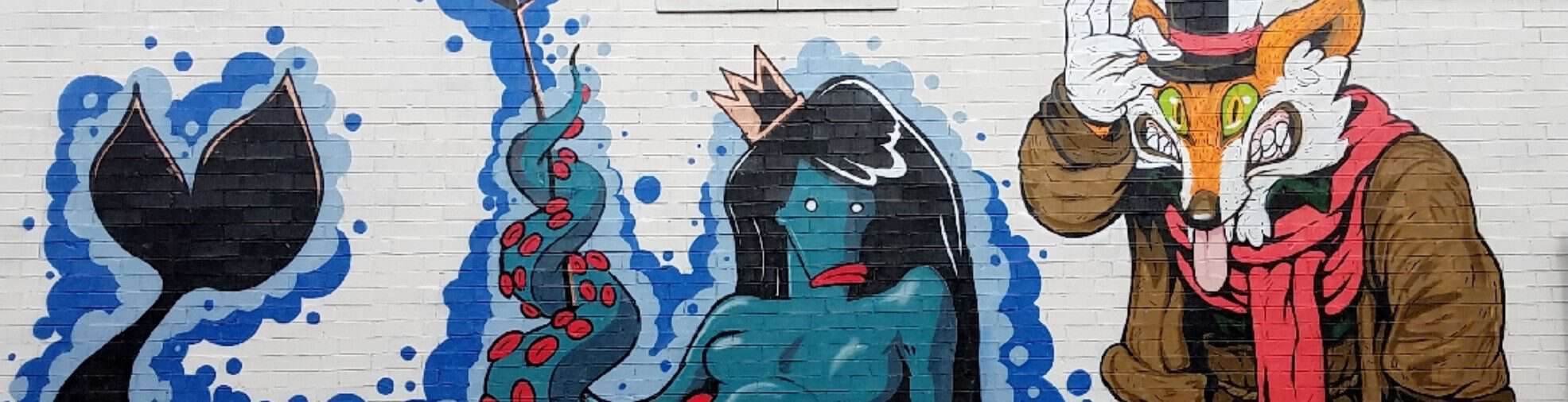 Mural by Courtney Hicks and Pitoto featuring a fox and a mermaid