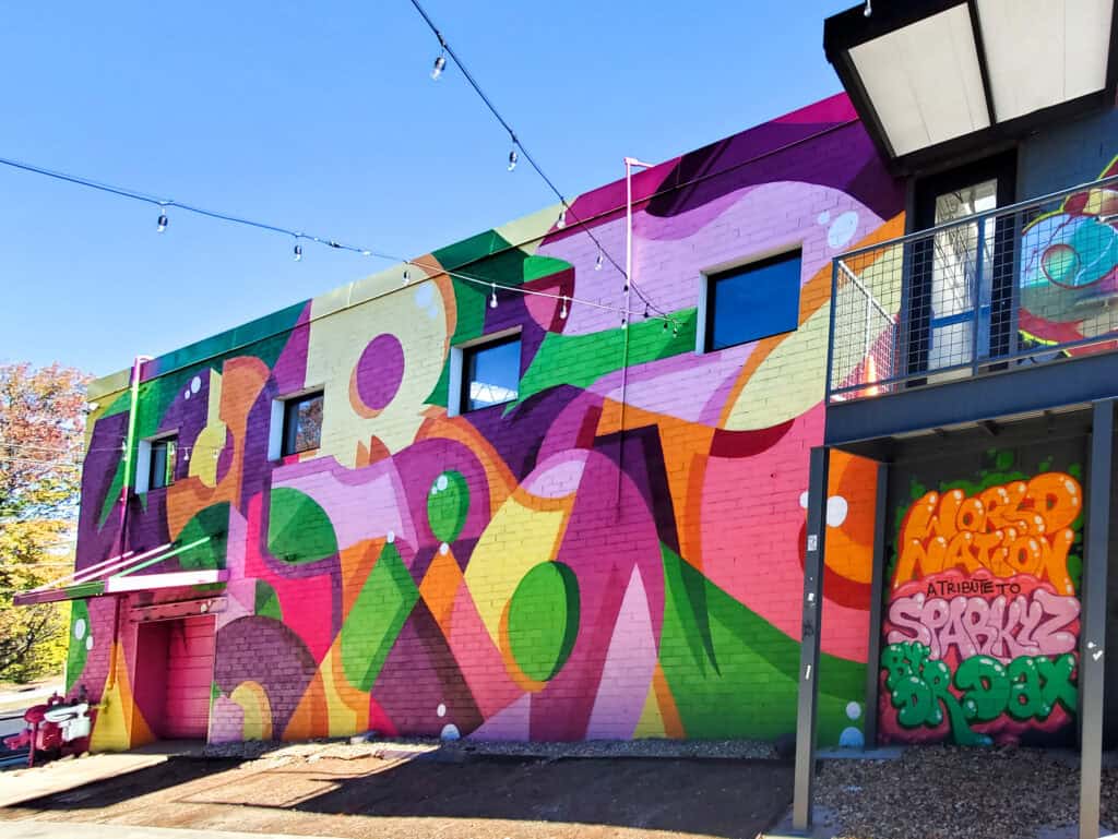 Street Art Mural in West End Atlanta by Dr. Dax (Dax Rudnak) featuring "World Nation" painted for Atlanta Style Writer's Jam 2024