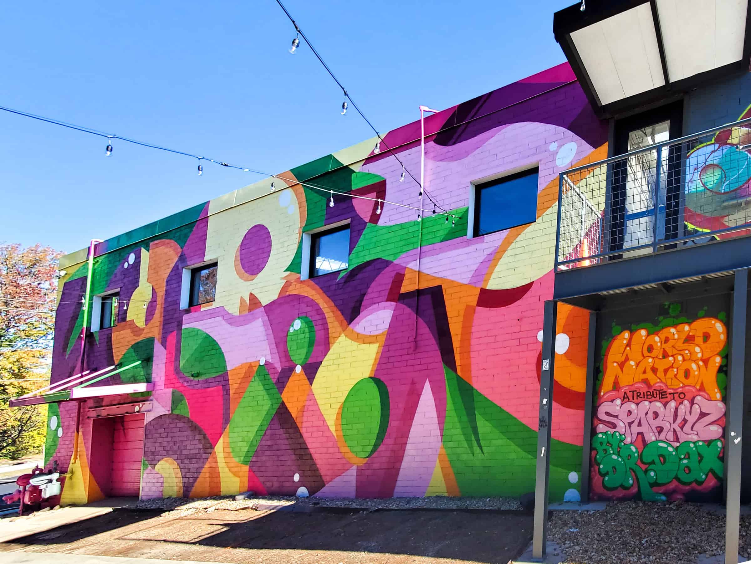 Street Art Mural in West End Atlanta by Dr. Dax (Dax Rudnak) featuring "World Nation"