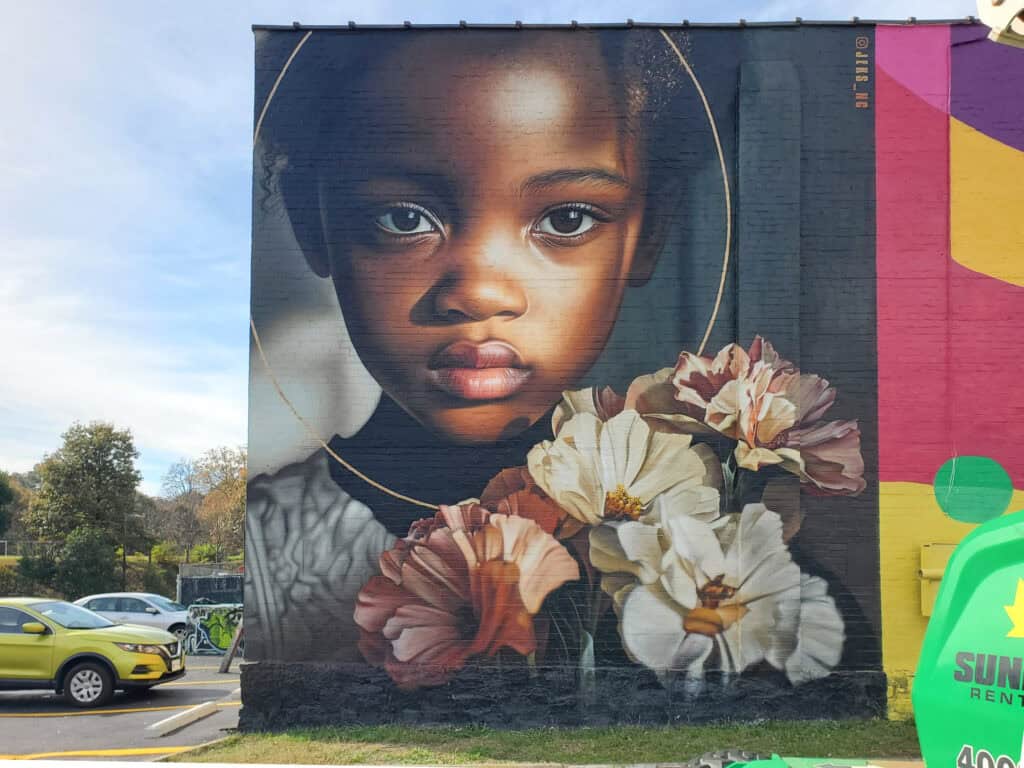 Street Art Mural by JEKS (Brian Lewis) in Little Five Points Atlanta featuring a girl with flowers