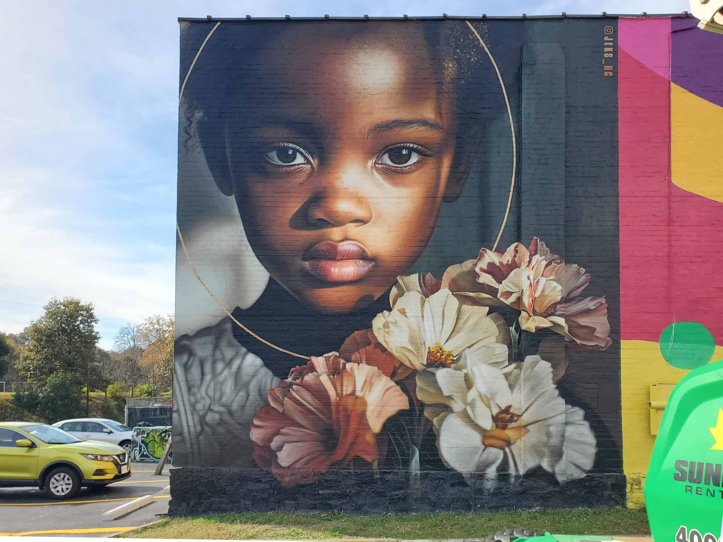 Street Art Mural by JEKS (Brian Lewis) in Little Five Points Atlanta featuring a girl with flowers
