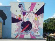 Tommy Bronx<br/>2017 - 2022<br/><span style= "font-size: 6pt">33.75223330635267, -84.37010306737137</span> Street Art Mural formerly in Old Forth Ward Atlanta by Tommy Bronx featuring a woman sitting on a planet