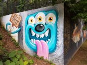 Greg Mike<br/>2015 - 2018<br/><span style= "font-size: 6pt">33.75746144112695, -84.3651072830719</span> street art mural formerly on the BeltLine in Old Fourth Ward Atlanta by Greg Mike featuring a three eyed blue creature