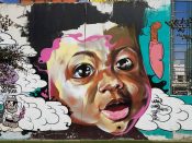 Lonnie Garner<br/>2017 - 2019<br/><span style= "font-size: 6pt">33.75244219890993, -84.3626508007007</span> Forward Warrior Mural formerly in Cabbagetown Atlanta by Lonnie Garner featuring a baby's face