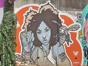 Dubelyoo<br/>2015 - 2021<br/><span style= "font-size: 6pt">33.751562673929136,-84.36633209325407</span> Street Art Mural formerly in Cabbagetown Atlanta by Dubleyoo featuring a woman and a bee