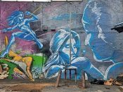 Mr. Totem 2<br/>2014 - 2019<br/><span style= "font-size: 6pt">33.76474997496147, -84.3497101476305</span> Street Art Mural formerly in Little Five Points Atlanta by Mr. Totem 2 featuring three characters in blue