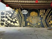 Rising Red Lotus (Brandon Sadler)<br/>2017 - 2021<br/><span style= "font-size: 6pt">33.734185878286816,-84.39872398954765</span> Street Art mural formerly in Mechanicsville Atlanta by Brandon Sadler featuring a face with glasses saying "wake up"