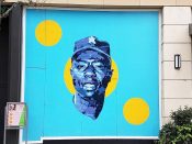 Tyrus Lytton<br/>2017 - 2018<br/><span style= "font-size: 6pt">33.83788891518858, -84.38083938568782</span> Street Art Mural formerly in Buckhead Atlanta by Tyrus Lytton featuring a man in a baseball cap