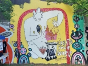 Loudermilk and Moon<br/>2018 - 2023<br/><span style= "font-size: 6pt">33.75154599355054, -84.36633027981968</span> Forward Warrior mural formerly in Cabbagetown Atlanta by Loudermilk and Moon featuring a figure sitting under a red arch