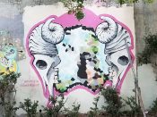 Marcy Starz and Laura Vela<br/>2018 - 2021<br/><span style= "font-size: 6pt">33.752088, -84.363808</span> Forward Warrior Mural formerly in Cabbagetown Atlanta by Marcy Starz and Laura Vela featuring two animal sculls with horns