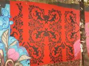 Shanequa Gay<br/>2018 - 2020<br/><span style= "font-size: 6pt">33.751243274841976, -84.36683937351397</span> Forward Warrior Mural formerly in Cabbagetown Atlanta by Shaniqua Gay featuring a red and black pattern