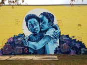 Brandan B-Mike Odums<br/>2018 - 2025<br/><span style= "font-size: 6pt">33.75144159237789, -84.39337152884252</span> Street Art Mural formerly in Southwest Downtown Atlanta by Brandan B-Mike Odums featuring two kids hugging