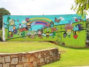 Olive47<br/>2016? - 2026<br/><span style= "font-size: 6pt">33.75994359573432, -84.30374294796214</span> Street Art Mural formerly in Oakhurst Atlanta by Olive47 featuring kids playing