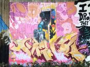 Frank Morrison<br/>2019 - 2022<br/><span style= "font-size: 6pt">33.75205240515721, -84.3642625584023</span> Street Art Mural formerly in Cabbagetown Atlanta by Frank Morrison featuring a child playing a video game