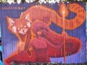 Amy Ashbaugh<br/>2019 - 2020<br/><span style= "font-size: 6pt">33.751846523184334, -84.36495924636422</span> Street Art Mural formerly in Cabbagetown Atlanta by Amy Ashbaugh featuring a woman and a racoon