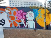 Kai<br/>2019 - 2025<br/><span style= "font-size: 6pt">33.781921098704444, -84.38341767046545</span> Street Art Mural formerly in Midtown Atlanta by Kai featuring a money bag and a smiley balloon