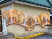 Mr. Totem 2<br/>2011 - 2022<br/><span style= "font-size: 6pt">33.891522989878254,-84.32564590824684</span> Street Art Mural formerly in Northwest Atlanta by Mr. Totem 2 featuring a Pizza Chef and a cityscape