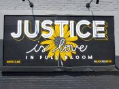 Elaine Stephenson<br/>2020 - 2024<br/><span style= "font-size: 6pt">33.75094558036409, -84.30934019057537</span> Street Art Mural formerly in East Lake Atlanta by Elaine Stephenson featuring "Justice" and a flower