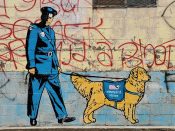 Sever<br/>2021 - 2025<br/><span style= "font-size: 6pt">33.74649745191224, -84.36411981521832</span> Street Art Mural formerly in Grant Park Atlanta by Sever featuring a policeman and a dog