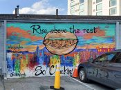 Ashley Dopson<br/>2021 - 2022<br/><span style= "font-size: 6pt">33.76220334161414, -84.39641109841291</span> Street Art Mural formerly in Downtown Atlanta by Ashley Dopson featuring a chicken sandwich