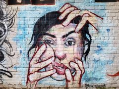 Lucy Luckovich<br/>2021? - 2026<br/><span style= "font-size: 6pt">33.751179, -84.393974</span> Street Art Mural formerly in SW Downtown Atlanta by Lucy Luckovich featuring a woman with hands on her face