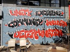 Street Art Mural formerly on the BeltLine in Old Fourth Ward Atlanta by Dr. Dax (Dax Rudnak) featuring "Unity Excellence..."