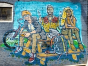 Chris Makes Art (Chris Wright)<br/>2022 - 2022<br/><span style= "font-size: 6pt">33.74936407136085, -84.36789091250739</span> Street Art Mural formerly in Cabbagetown Atlanta by Chris Makes Art (Chris Wright) featuring three people at a picnic table