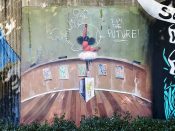 Frank Morrison<br/>2022 - 2025<br/><span style= "font-size: 6pt">33.752022532133864, -84.36425855327788</span> Street Art Mural formerly in Cabbagetown Atlanta by Frank Morrison featuring a girl writing on a blackboard