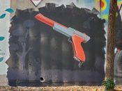 Petie Parker (Kareem Thompson)<br/>2022 - 2025<br/><span style= "font-size: 6pt">33.75178811849015, -84.36523062989589</span> Street Art Mural formerly in Cabbagetown Atlanta by Petie Parker (Kareem Thompson) featuring a Duck Hunt Gun