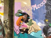 Charity Hamidullah<br/>2022 - 2023<br/><span style= "font-size: 6pt">33.75124031585061, -84.36684544242053</span> Street Art Mural formerly in Cabbagetown Atlanta by Charity Hamidullah featuring a woman with an orange arm