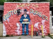 Allen London<br/>2018 - 2024<br/><span style= "font-size: 6pt">33.76376878242961, -84.41707679640096</span> Street Art Mural formerly in Vine City Atlanta by Allen London featuring "Ghetto Burger"