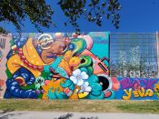 Drew Borders and Killamari<br/>2023 - 2024<br/><span style= "font-size: 6pt">33.752410154862986, -84.36272782457982</span> Street Art Mural formerly in Cabbagetown Atlanta by Drew Borders and Killamari featuring a person with several things on their head