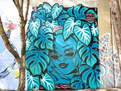 Street Art Mural formerly in Cabbagetown Atlanta by Wes Holland featuring a face surrounded by leaves