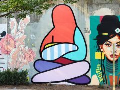 Street Art Mural formerly in Cabbagetown Atlanta by Yoyo Ferro featuring a seated figure