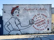 Upper Westside Murals<br/>2023 - 2025<br/><span style= "font-size: 6pt">33.80847120887715, -84.4121582390305</span> Street art mural formerly in Buckhead Atlanta by Upper Westside Murals featuring a sign for Doughnut Dollies