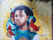 Derrick Phillips Sr.<br/>2023 - 2025<br/><span style= "font-size: 6pt">33.751636334111794, -84.36588908979103</span> Street Art Mural formerly in Cabbagetown Atlanta by Derrick Phillips Sr. featuring a young man with three birds