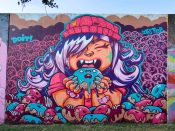 Doit Doit (Mario Daniel) and Oofster (Pierre Cerrato)<br/>2024 - 2025<br/><span style= "font-size: 6pt">33.75237085243646, -84.3628683759746</span> Street Art Mural formerly in Cabbagetown Atlanta by Doit Doit (Mario Daniel) and Oofster (Pierre Cerrato) featuring a woman eating an anthropomorphic donut