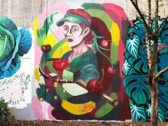 Street Art Mural formerly in Cabbagetown Atlanta by Melanie Paulos featuring a woman with a tennis racquet
