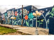 Ouzi (Louise Jones)<br/>2017 - 2024<br/><span style= "font-size: 6pt">33.77386101546, -84.3646031681307</span> Building facade mural formerly on the BeltLine in Virginia-Highland Atlanta by Ouizi (Louise Jones) featuring large flowers