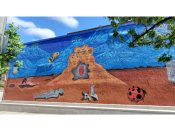 NomadicManny<br/>2021 - 2022<br/><span style= "font-size: 6pt">33.77486485619248, -84.2957186913411</span> Street Art Mural formerly in Decatur Georgia by NomadicManny featuring three faces on a sand pile