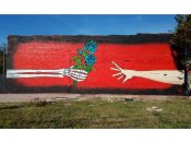 Denial (Daniel Bombardier)<br/>2018 - 2021<br/><span style= "font-size: 6pt">33.75405953089405, -84.37150842393748</span> Street Art Mural formerly in Old Fourth Ward Atlanta by Daniel Bombardier featuring a skeleton hand holding flowers