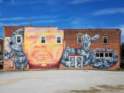 Gaia<br/>2012 - 2020<br/><span style= "font-size: 6pt">33.754172357574646, -84.37321473069045</span> Street Art Mural formerly in Sweet Auburn Atlanta by Gaia featuring an orange face