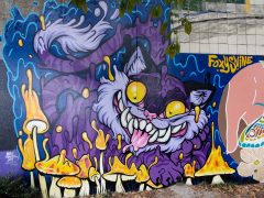 Chris Alvarez and Courtney Hicks<br/>2025<br/><span style= "font-size: 6pt">33.752034907412366, -84.36421416699942</span> Street Art Mural in Cabbagetown Atlanta by Chris Alvarez and Courtney Hicks featuring a cat eating mushroos