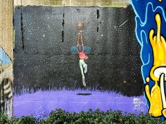 Frank Morrison<br/>2025 - <br/><span style= "font-size: 6pt">33.752022532133864, -84.36425855327788</span> Street Art Mural in Cabbagetown Atlanta by Frank Morrison featuring a girl playing basketball in the night sky