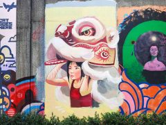 Street Art Mural formerly in Cabbagetown Atlanta by Trudy Tran featuring a woman with a lion dance costume