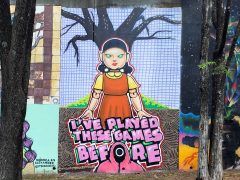 Street Art Mural formerly by in Cabbagetown Atlanta by Will Mitchell Featuring a doll with green eyes
