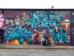 Graffiti pieces formerly in Little Five Points Atlanta by KAOS INC. featuring several characters