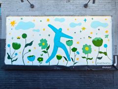 Street Art Mural formerly in Decatur GA by Vedika Mehra featuring a blue figure and flowers