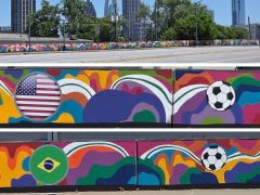 Melissa A. Mitchell<br/>2026 - <br/><span style= "font-size: 6pt">33.79125723314142, -84.4051308174015</span> Street Art Mural in West Midtown Atlanta by Melissa A. Mitchell featuring soccer balls and flags