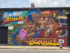 Artist ?<br/>2026 - <br/><span style= "font-size: 6pt">33.690464293404816, -84.51155787958965</span> Street Art Mural in Ben Hill Atlanta by an unknown artist featuring a man in a blue hat